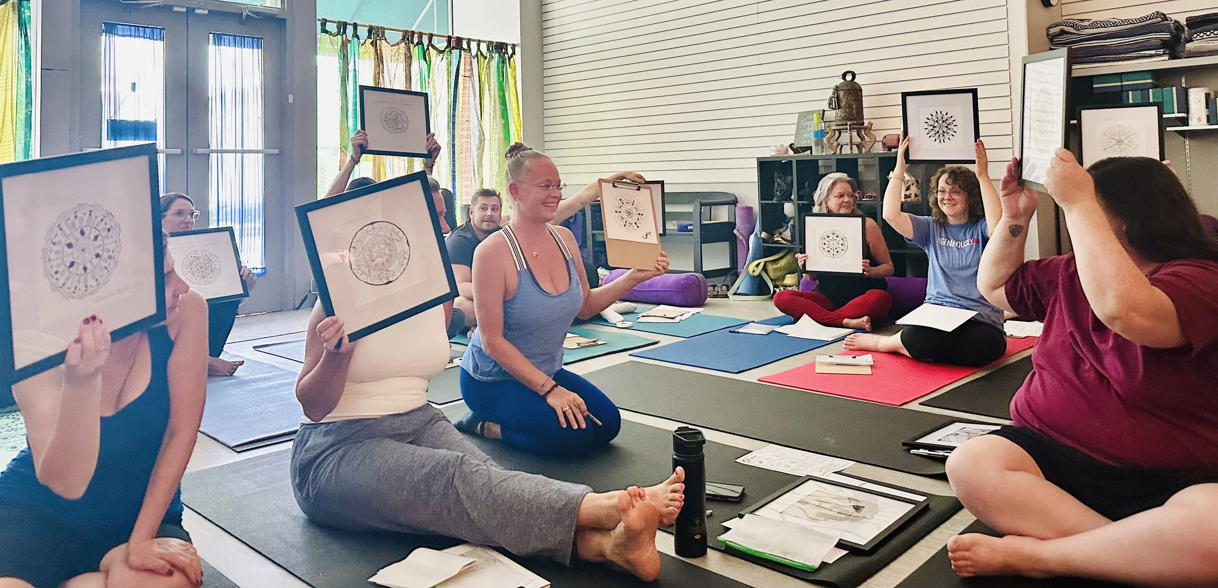 Participants at a Sumac Arts wellness event in Newberry, SC proudly display their hand-drawn framed mandala artwork