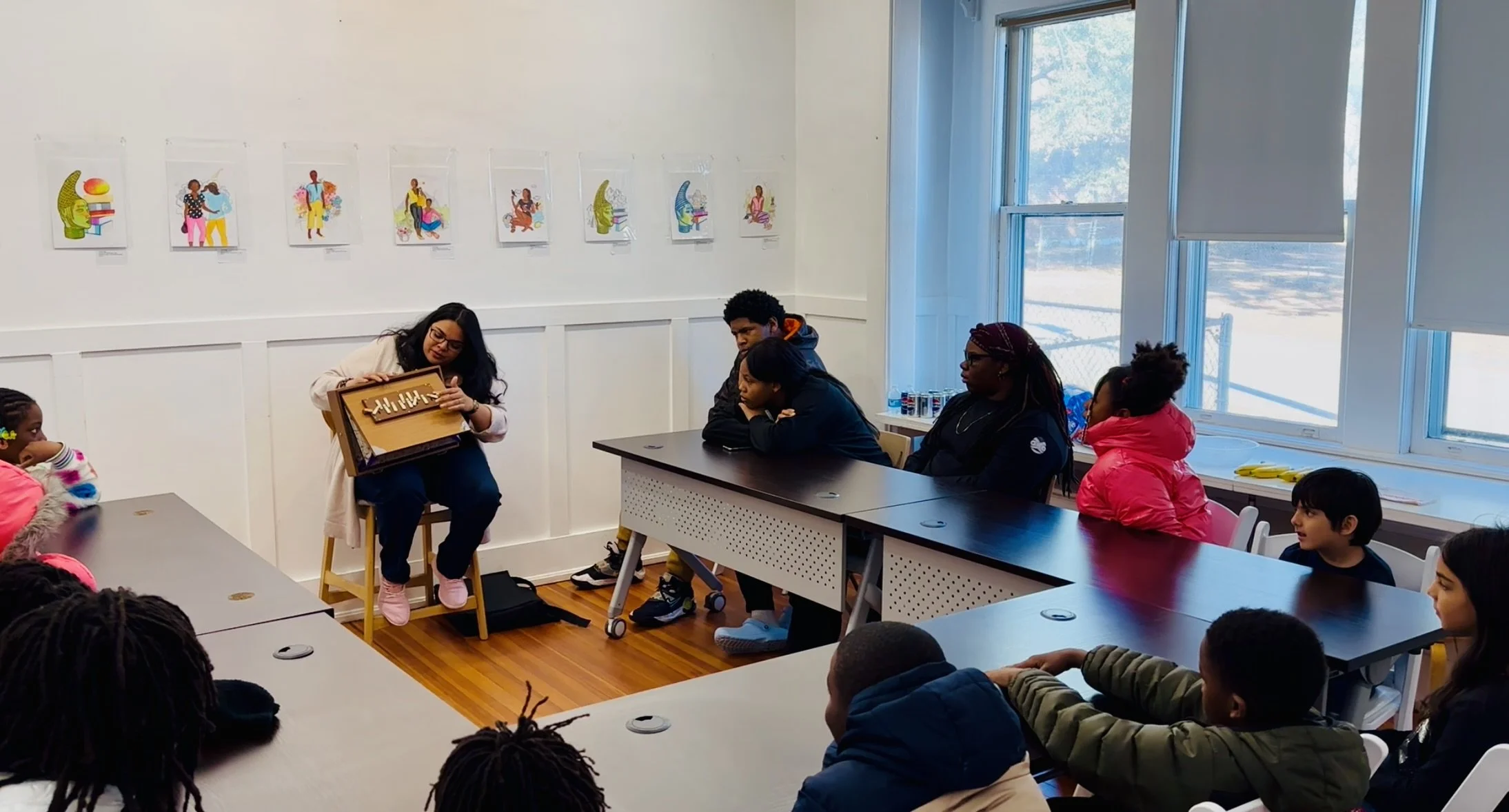 Sudha McFadden displays a shruti box while giving a talk to children and teens in Columbia, SCC