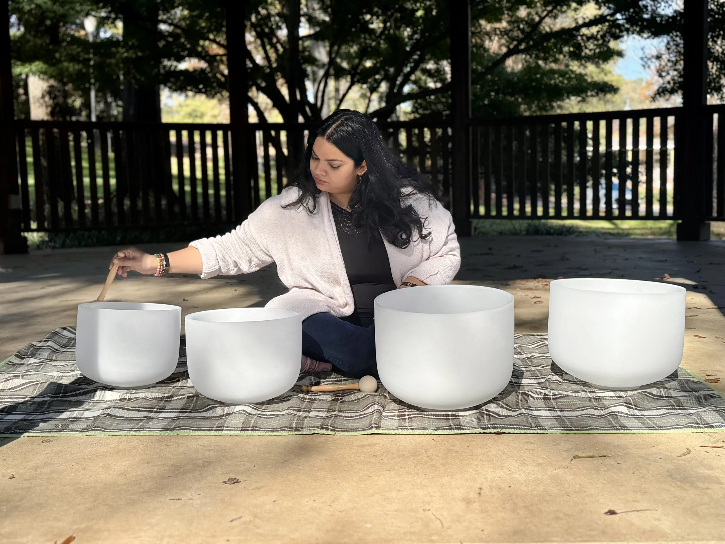 Sudha McFadden playing crystal singing bowls at a sound bath in South Carolina