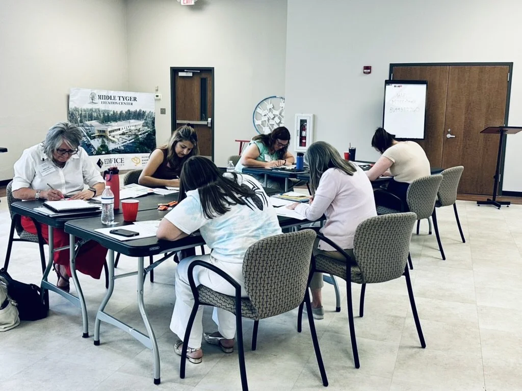 Participants seated at tables and drawing a mandala at a Sumac Arts resilience workshop in Lyman, South Carolina