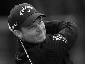 Golfer swinging golf club wearing Callaway cap