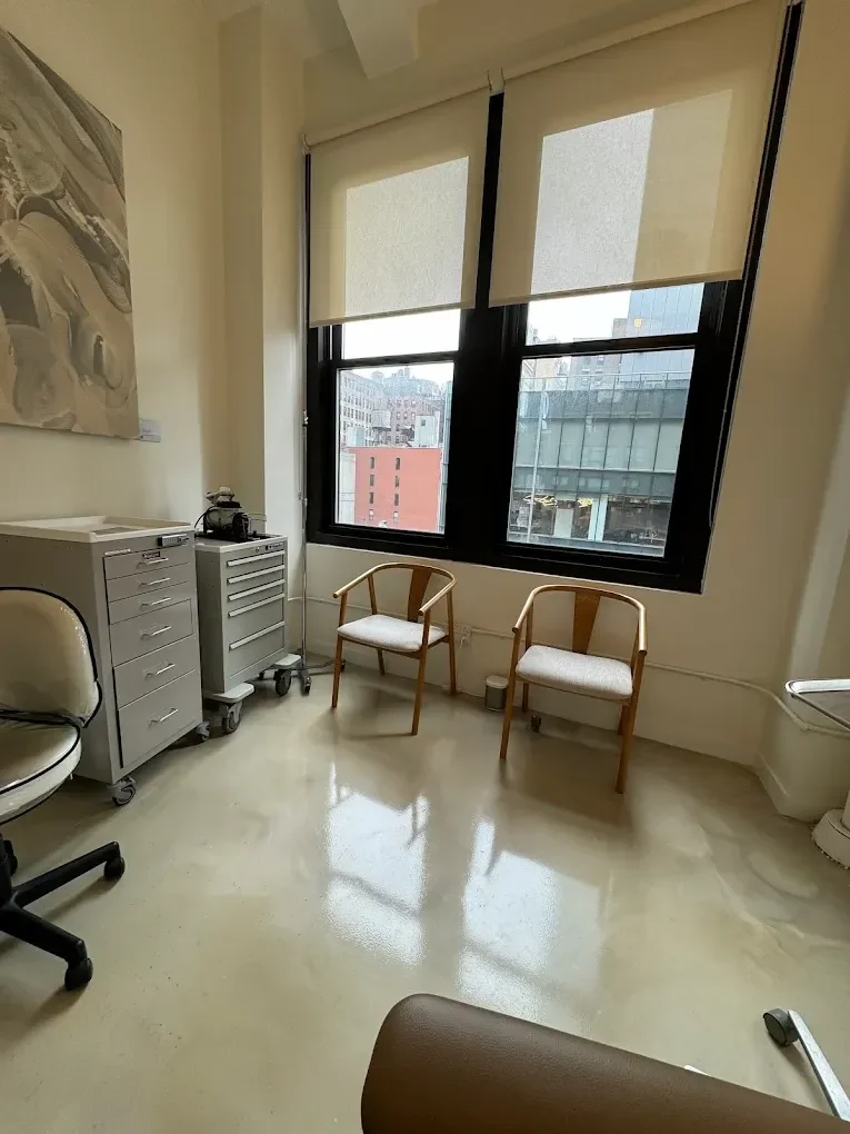 Person holding a modern, textured ceramic vase with a gradient from dark gray at the top to light gray at the bottom.