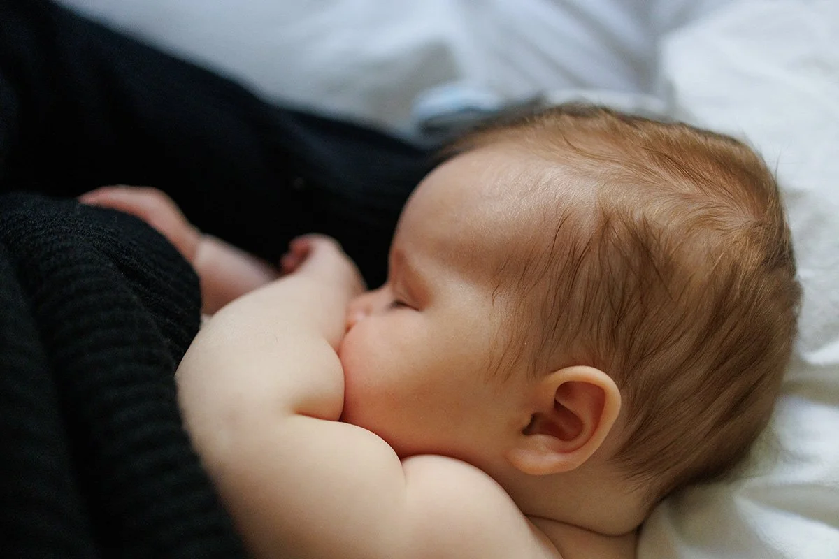 Newborn baby rests after breastfeeding - by Shannon Fisher Photo, a newborn photographer Orange County CA
