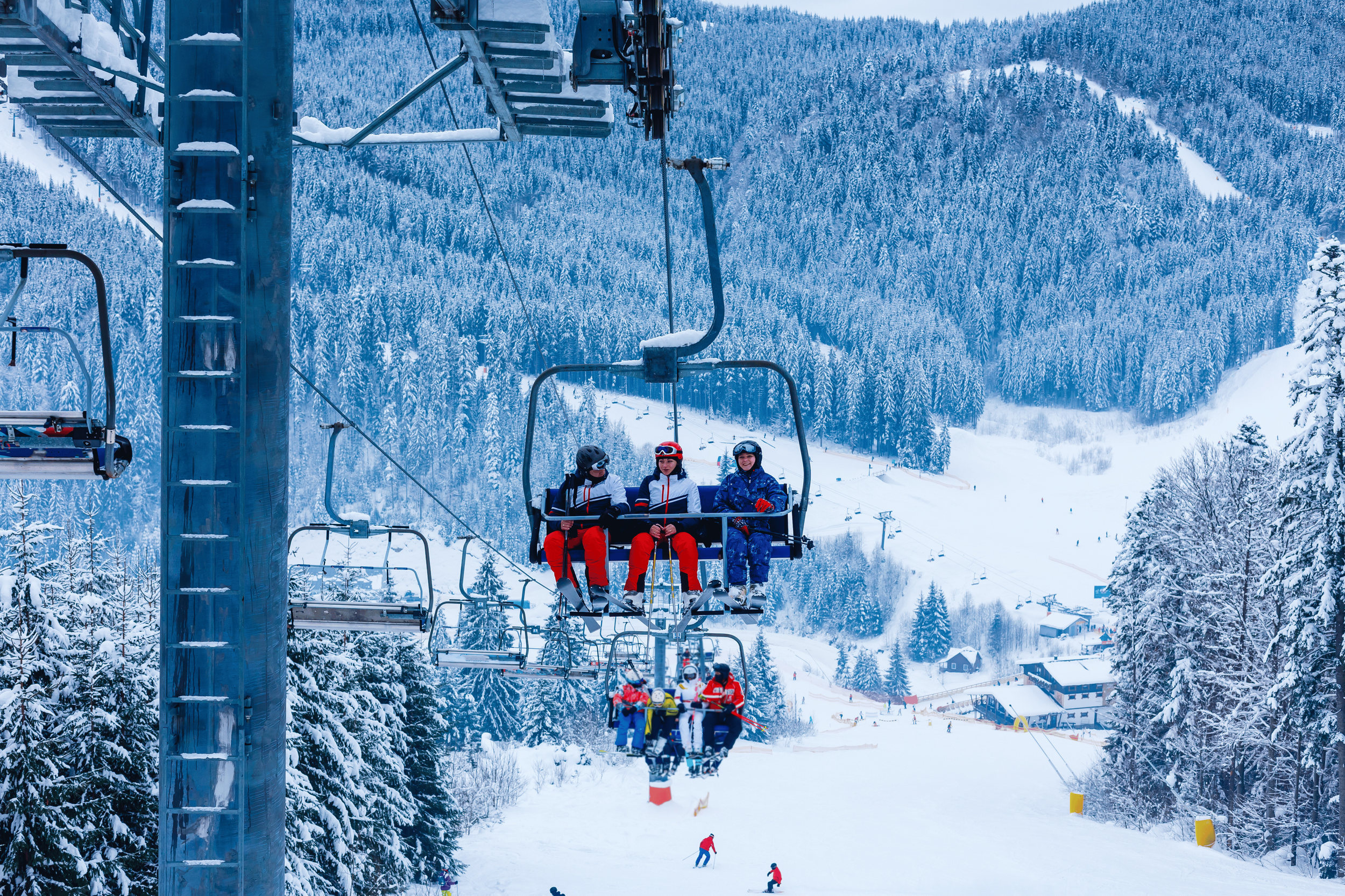 Skiers on chairlift in ski resort