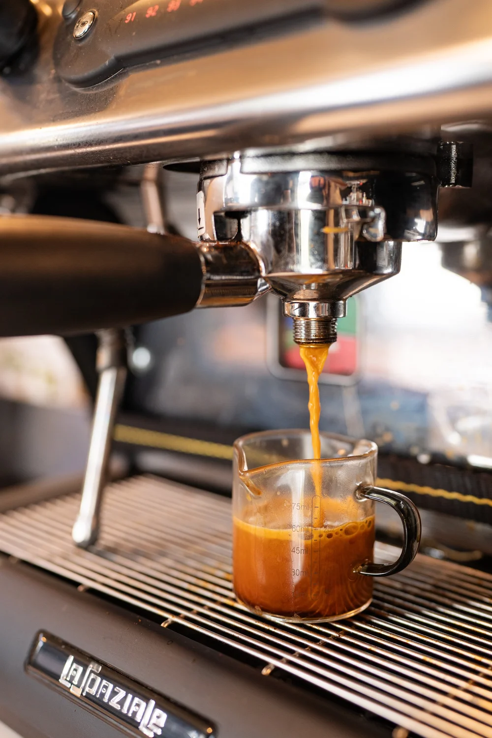 Espresso pouring from the machine into a glass