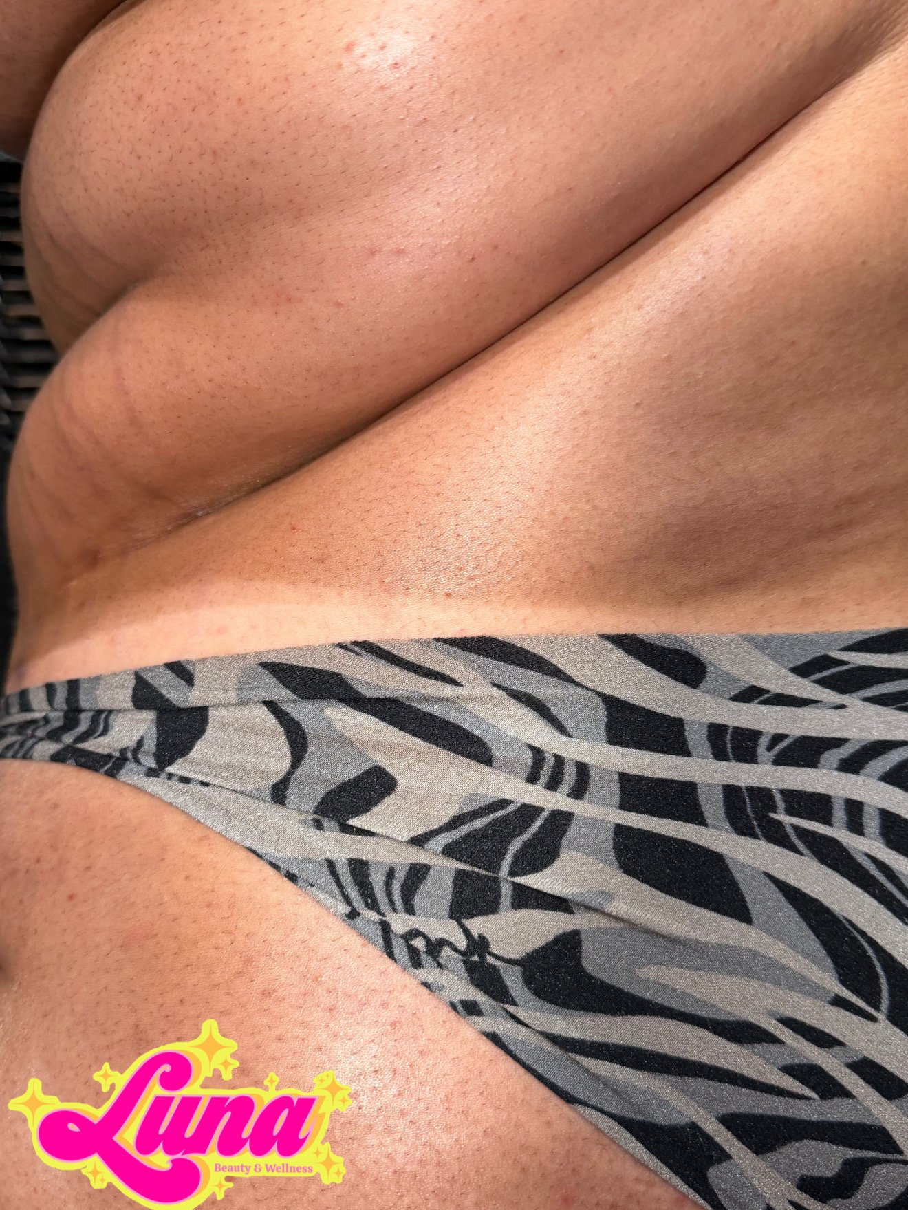 curvy body wearing bikini bottoms with a natural looking spray tan and tan line. Deep, brown spray tan at Luna Beauty and Wellness in Camarillo