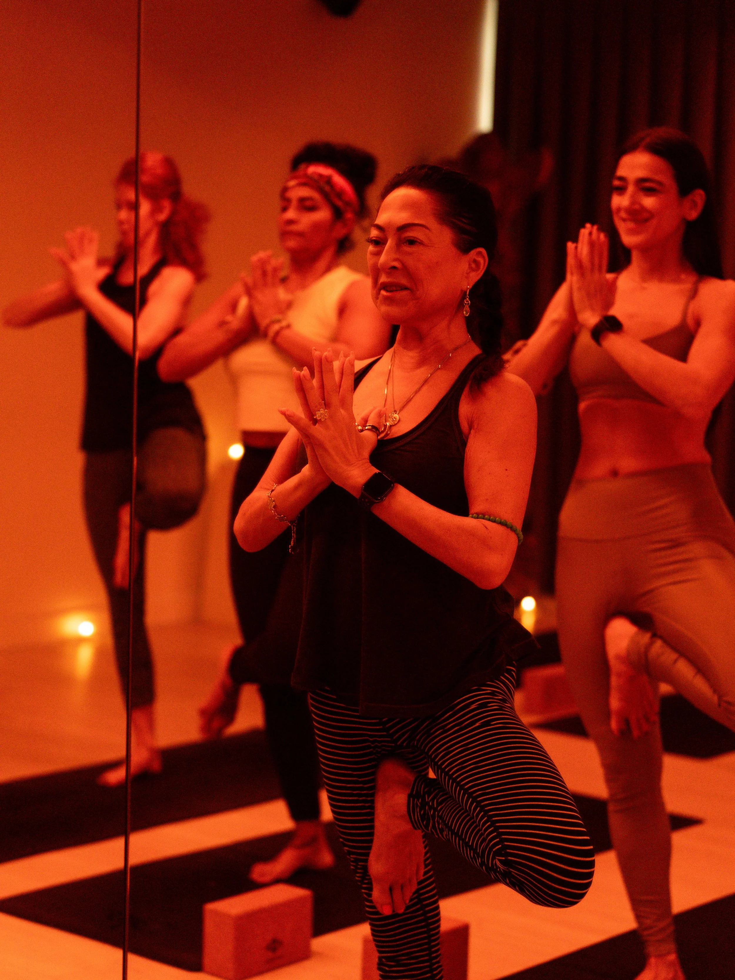 Person practicing hot yoga at their own pace, demonstrating an accessible and inclusive heated yoga practice