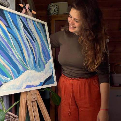 Bella with an abstract water painting on easel