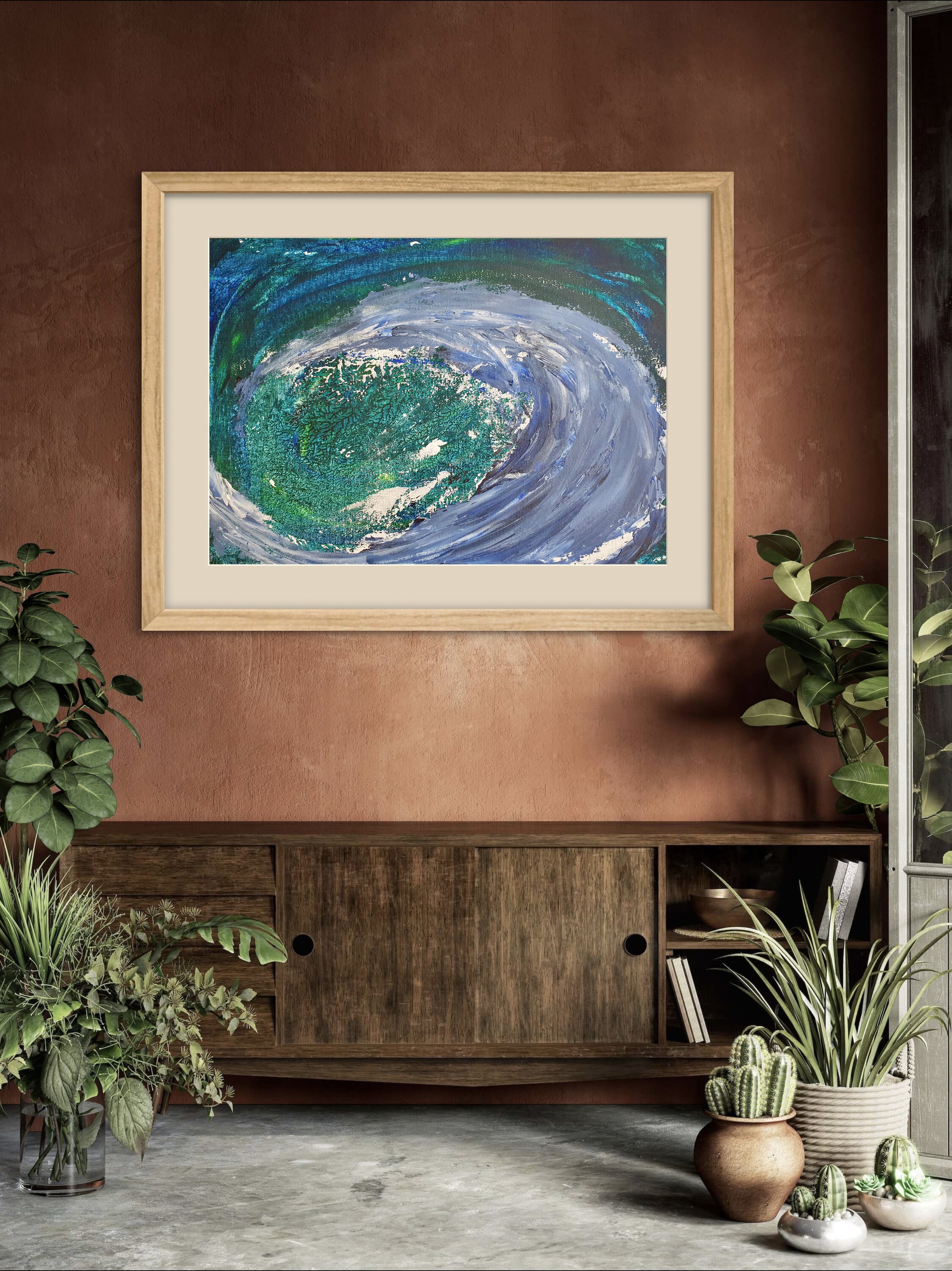 A framed abstract painting of a swirling ocean scene hangs on a reddish-brown wall in a room with plants and a wooden console.