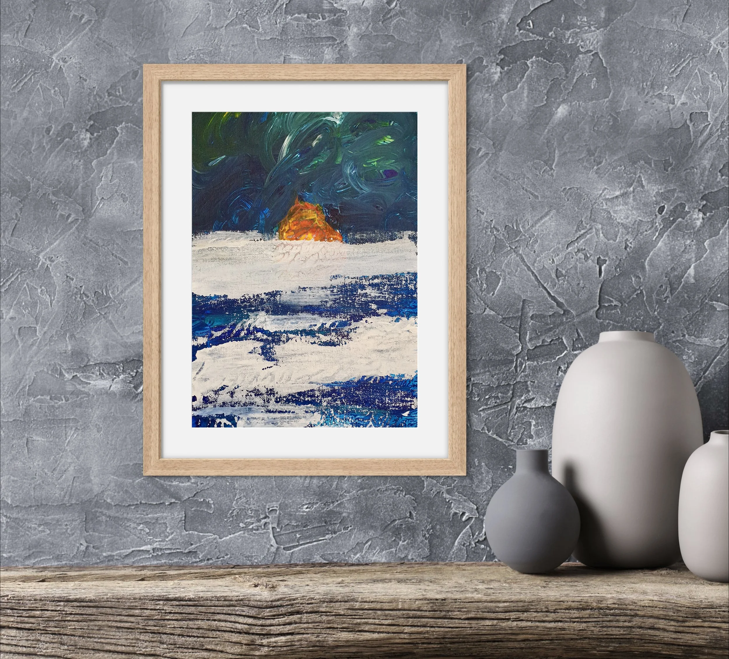 Abstract painting of the sunset with a fiery orange sun near the horizon, dark blue and green sky, and white and blue ocean waves, displayed in a wooden frame on a textured gray wall, with three gray and white ceramic vases on a rustic wooden surface