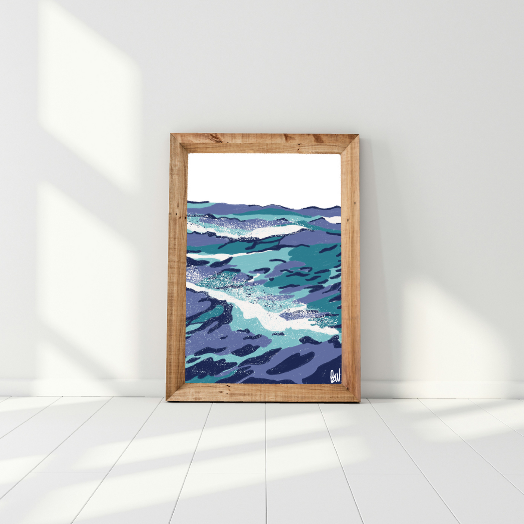 Painting of ocean waves in shades of blue, framed in wood, resting against a white wall.