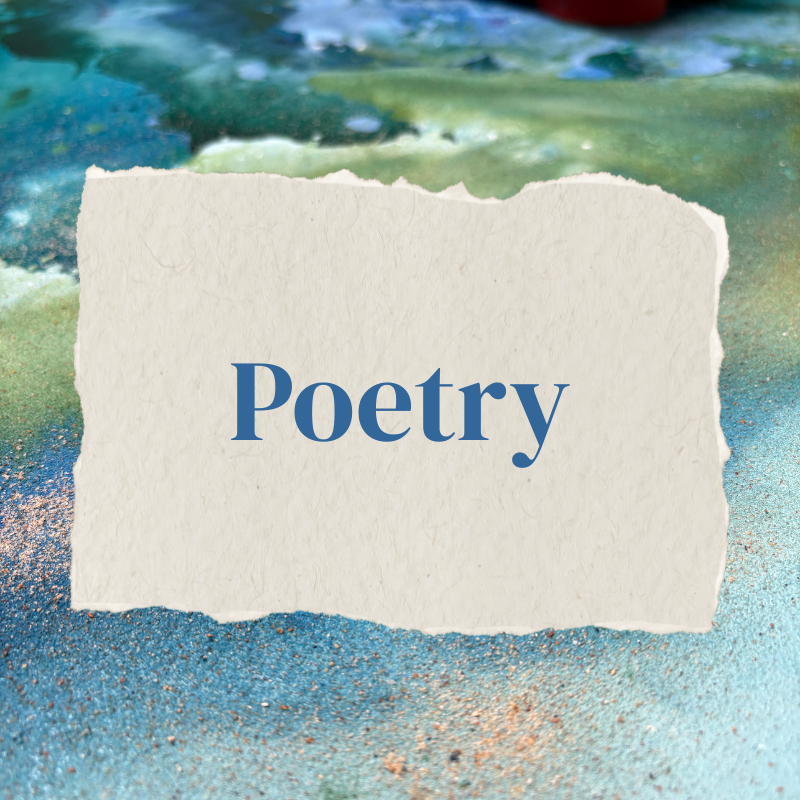 A torn piece of paper with the word 'Poetry' printed on it in blue, placed on a beach with sand and water in the background.