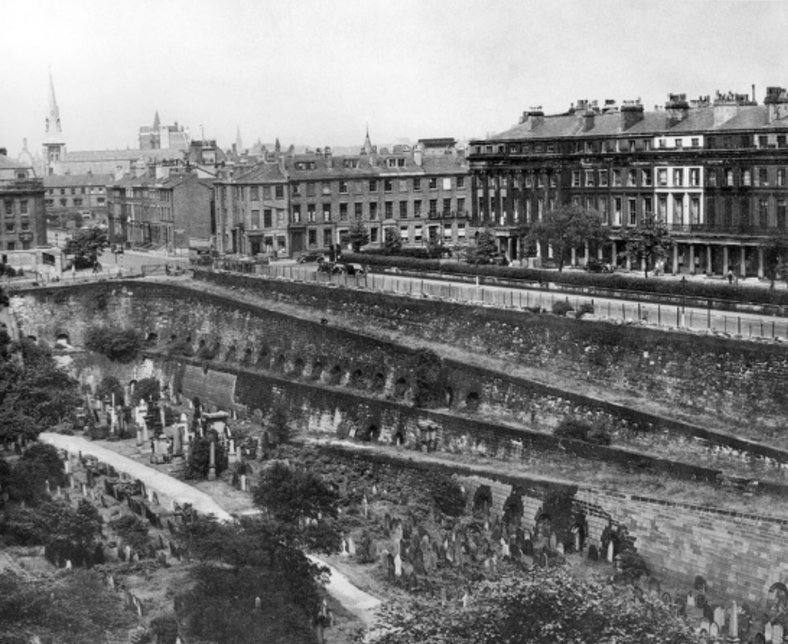 Gambier Terrace and Ramps
A photograph taken in the mid-20th century looking towards the north-eastern corner of the cemetery. The majority of the grounds are covered in gravestones and memorials. The catacombs and ramps of the east wall can be seen.