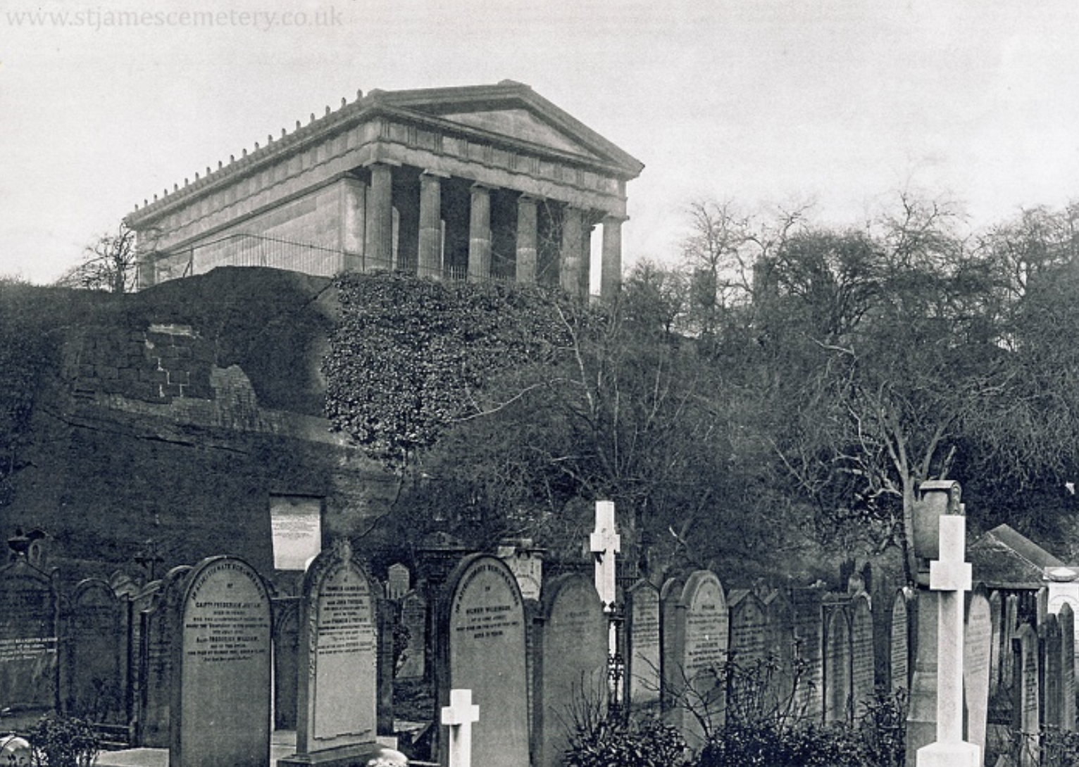 Oratory and Gravestones, 1896
This photograph shows the northern end of the cemetery in 1896. Rows of memorials are in the foreground of the image, with the oratory on the higher ground on top of the cliff behind. The memorials include three crosses,
