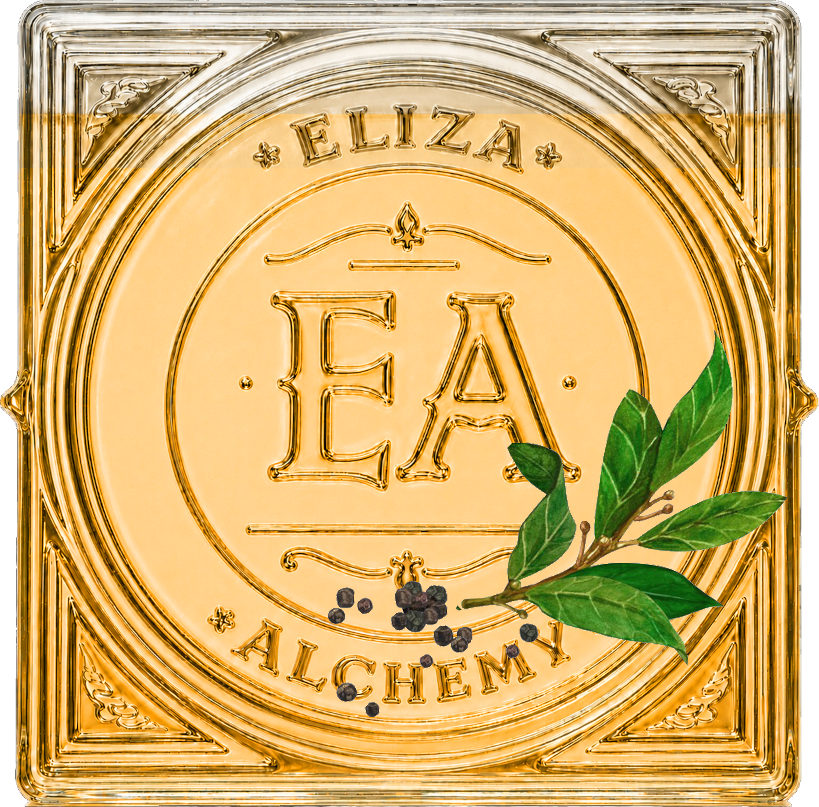 Decorative gold-colored square tile with the words 'ELIZA' and 'ALCHEMY' inscribed, a monogram 'E&A' in the center, a small branch with green leaves, and black peppercorns.