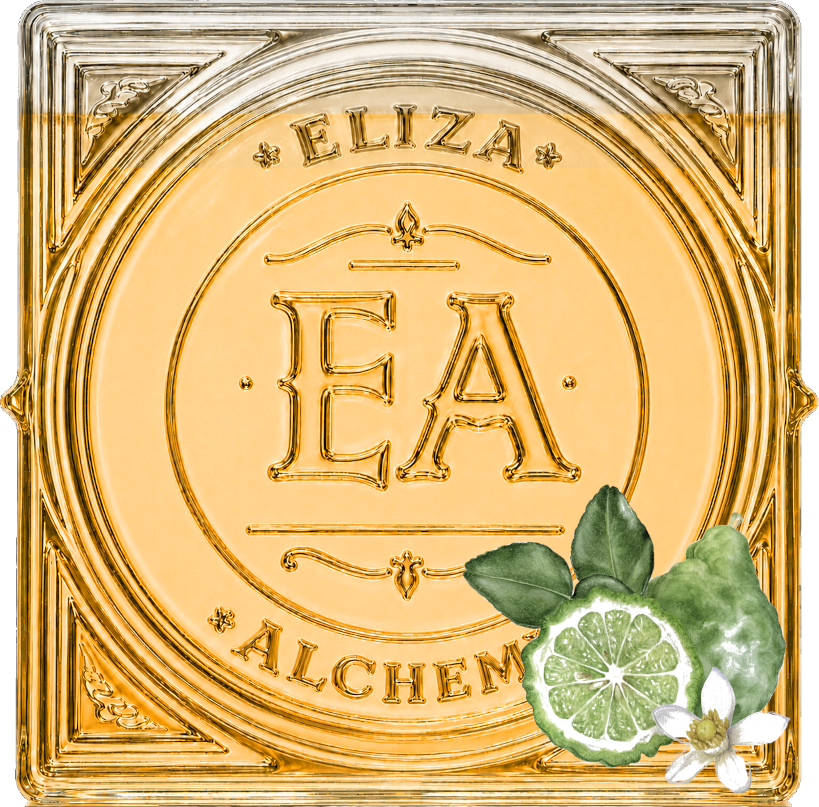 Decorative glass tile with the words "Eliza Alchemy" and the initials "E A" in the center. There are lemon slices, green leaves, and a white flower at the bottom right corner of the tile.