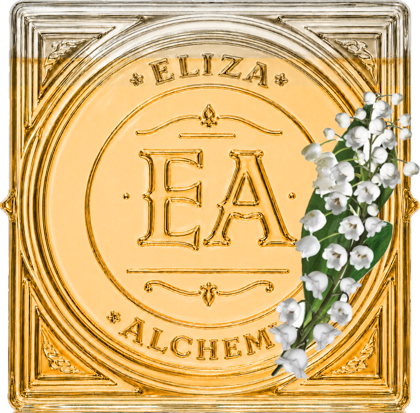 A square glass panel with gold embossed lettering, reading 'ELIZA ALCH EM' and a large central circular design with the initials 'E A'. A sprig of white flowers with green leaves is placed on the right side.
