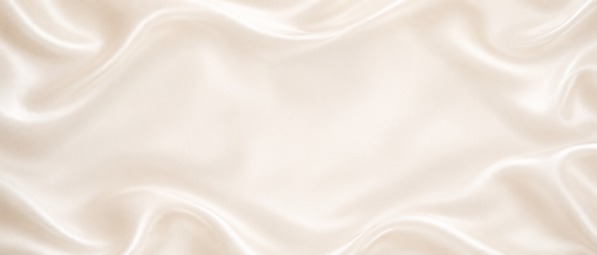 Close-up view of a smooth, shiny, cream-colored satin fabric with gentle folds and reflections.