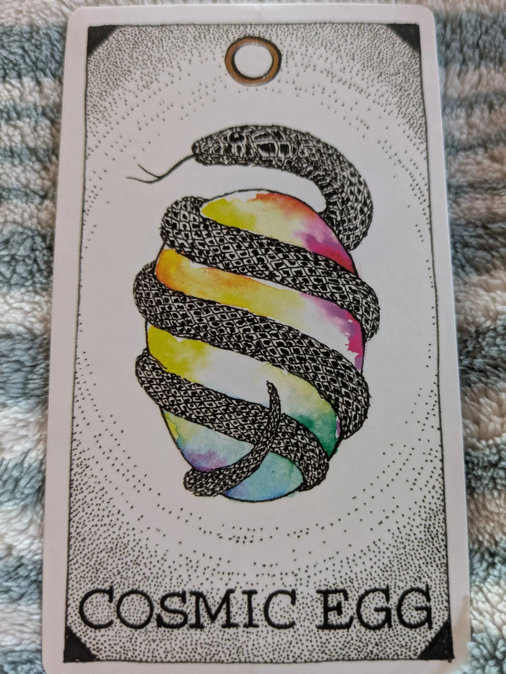 Cosmic Egg: A snake wrapped around an egg with the colors of the rainbow
