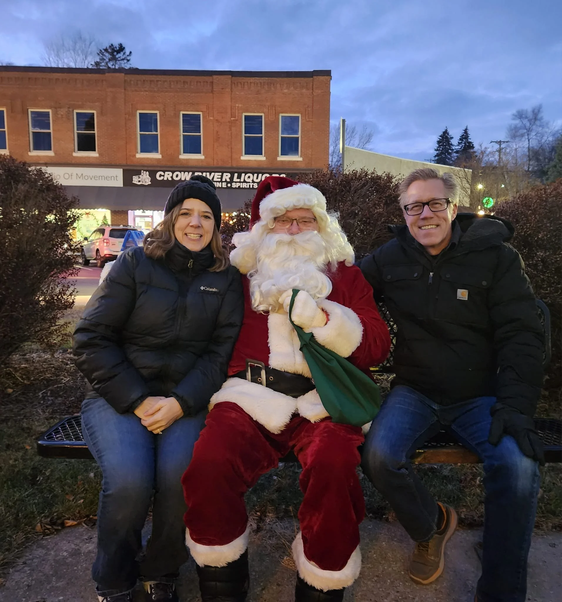 Deborah Everson and her husband Tracy siting with Santa at Watertown's Christmas Tree lighting in the Veterans Memorial.