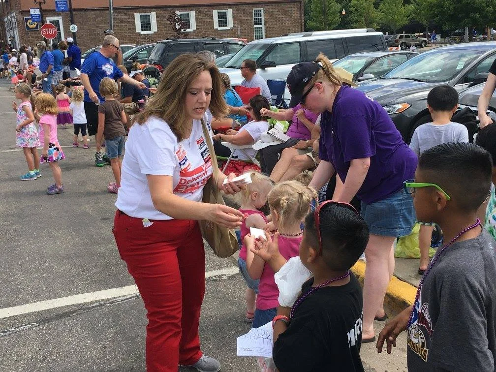 Deborah Everson greeting Watertown residence during the Rails-to-Trail Parade.