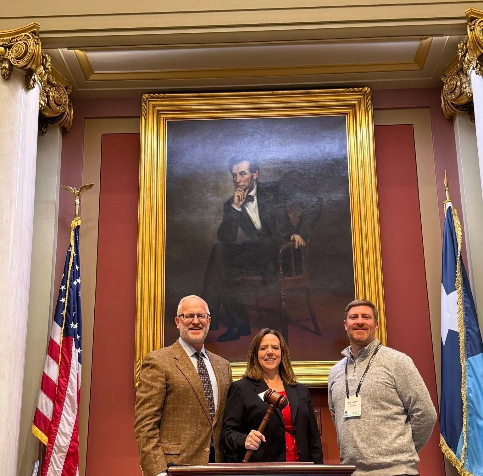 Deborah Everson and Watertown City Administrator Dan Tolsma meeting with Representative Jim Nash at the Podium in the Minnesota House of Representitives.