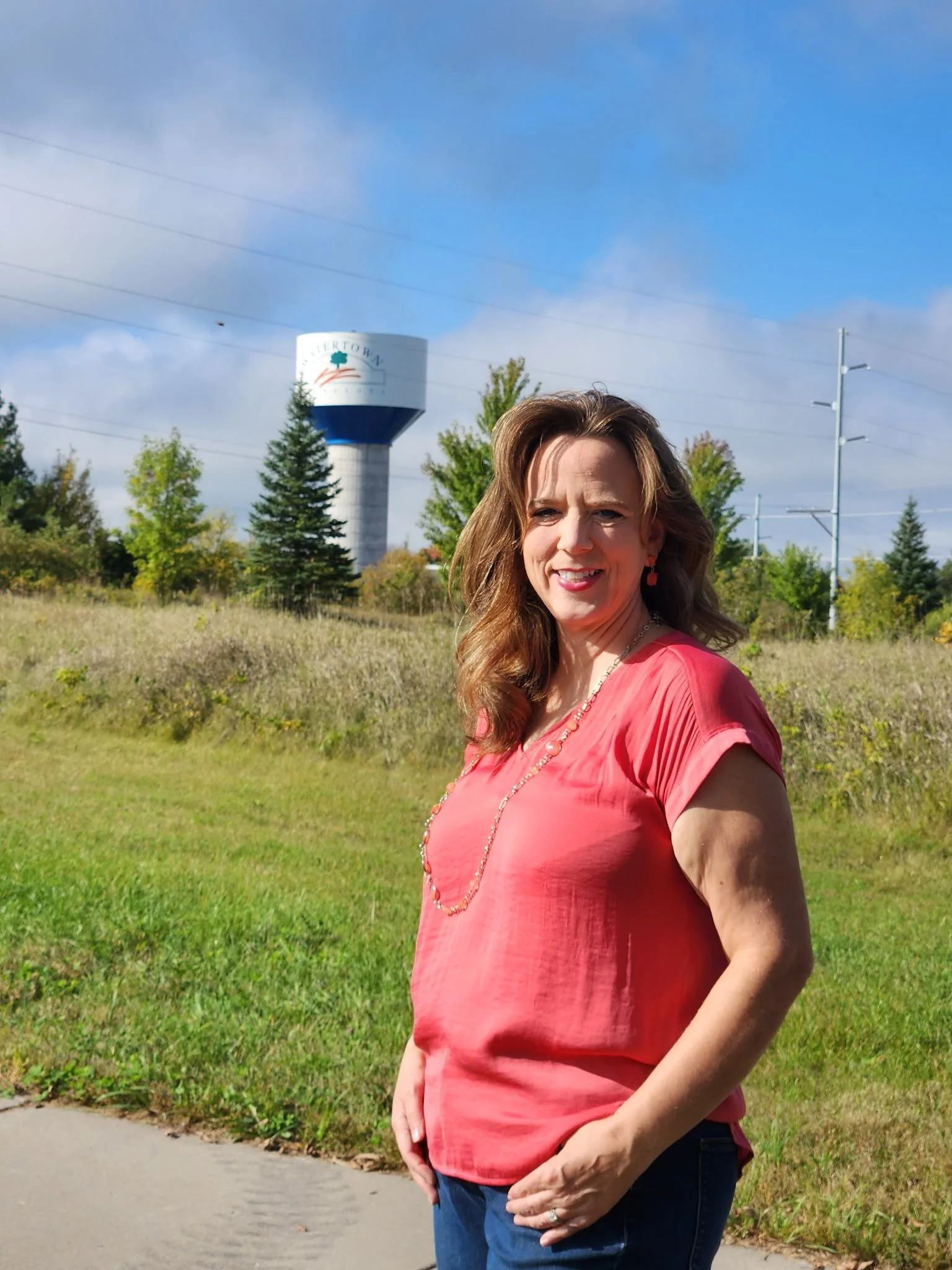 Deborah Everson standing with the new Watertown water tower in the background