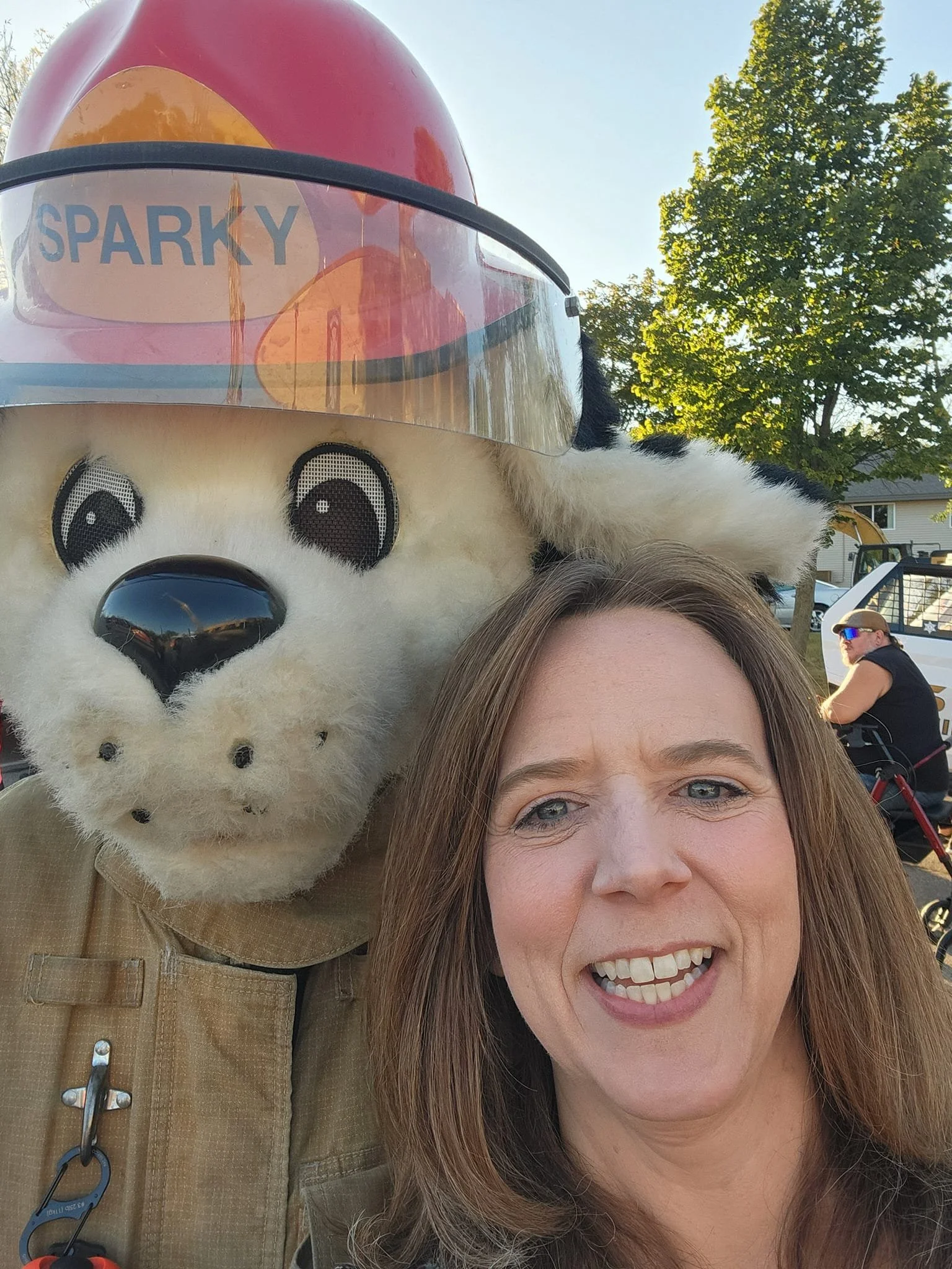 Deborah Everson posing with Watertown's fire department mascot Sparky.