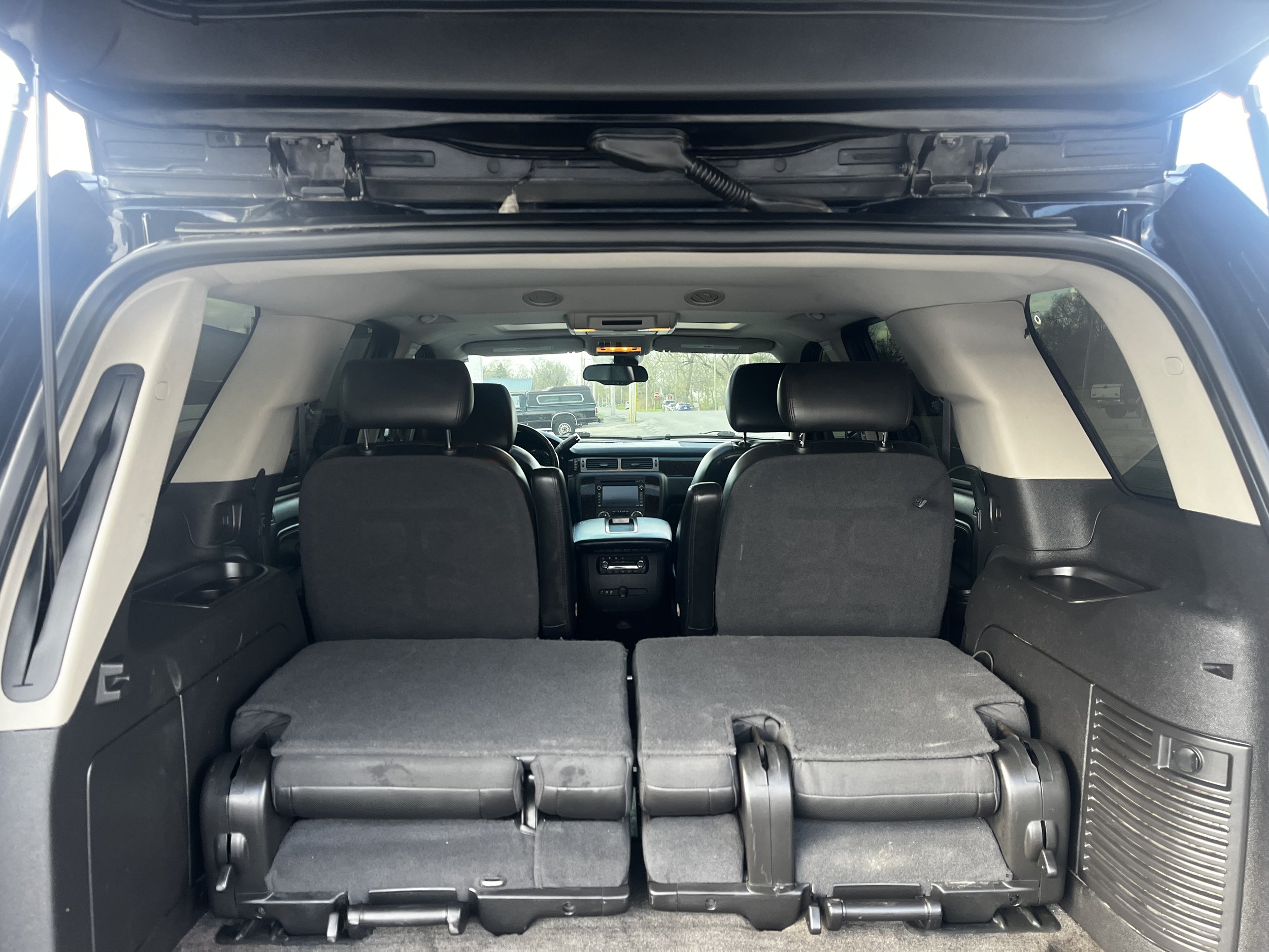 Interior view of an SUV with rear seats folded down, increasing cargo space.