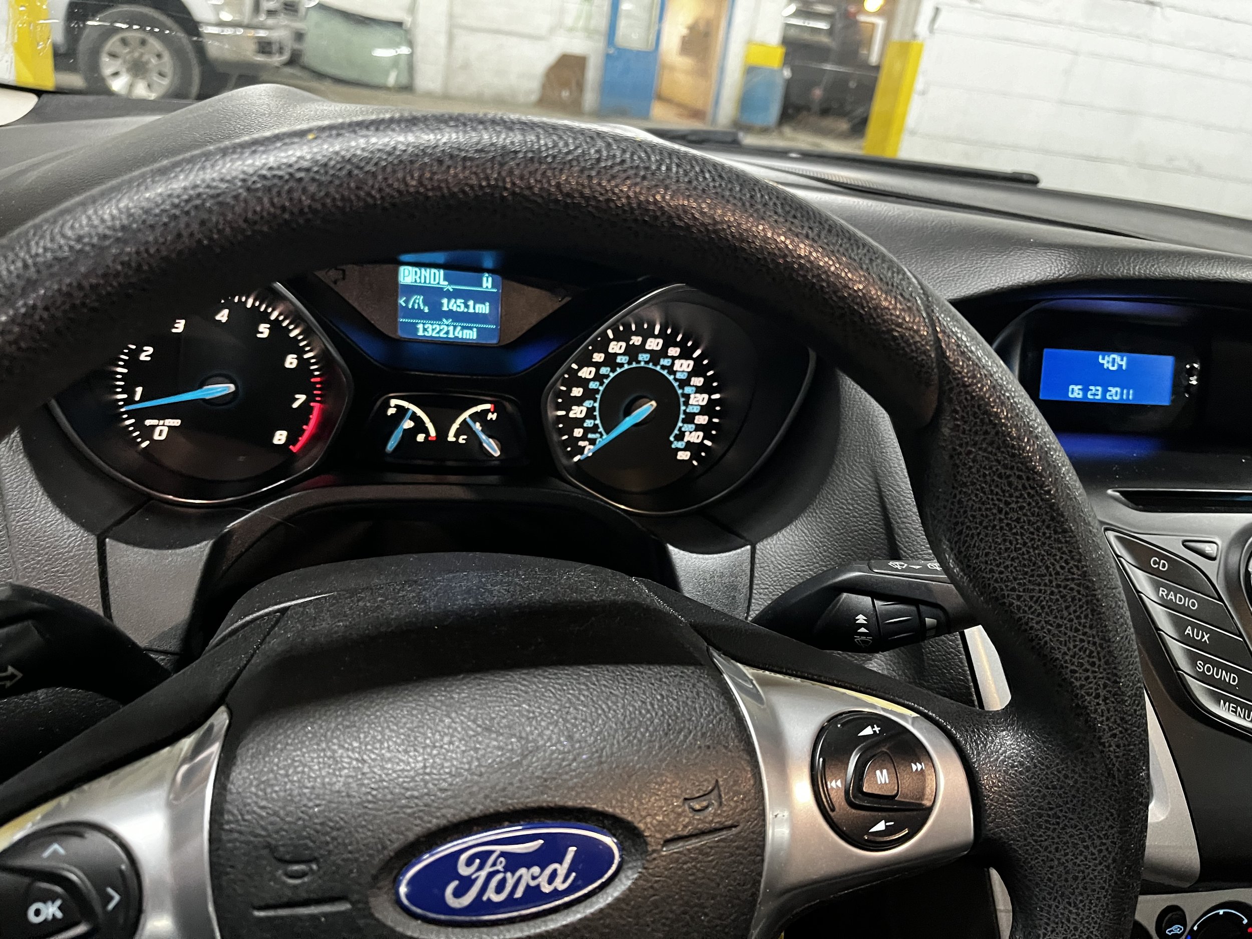 interior of a Ford car, showing dashboard and steering wheel, with gauges and controls