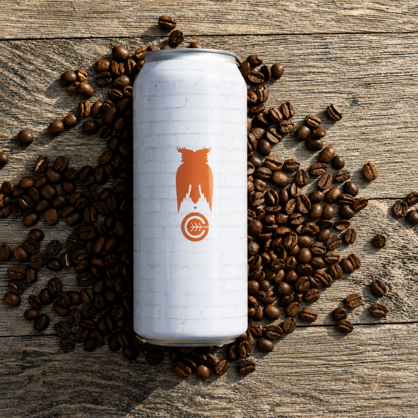 A white cylindrical can with a minimalistic logo of an orange owl with a cityscape silhouette on its chest, surrounded by coffee beans on a wooden surface.