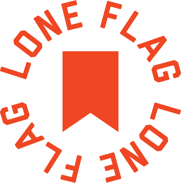 A circular logo with the text 'One Flag, One Land, One Flag' surrounding a red vertical banner inside a black circle.