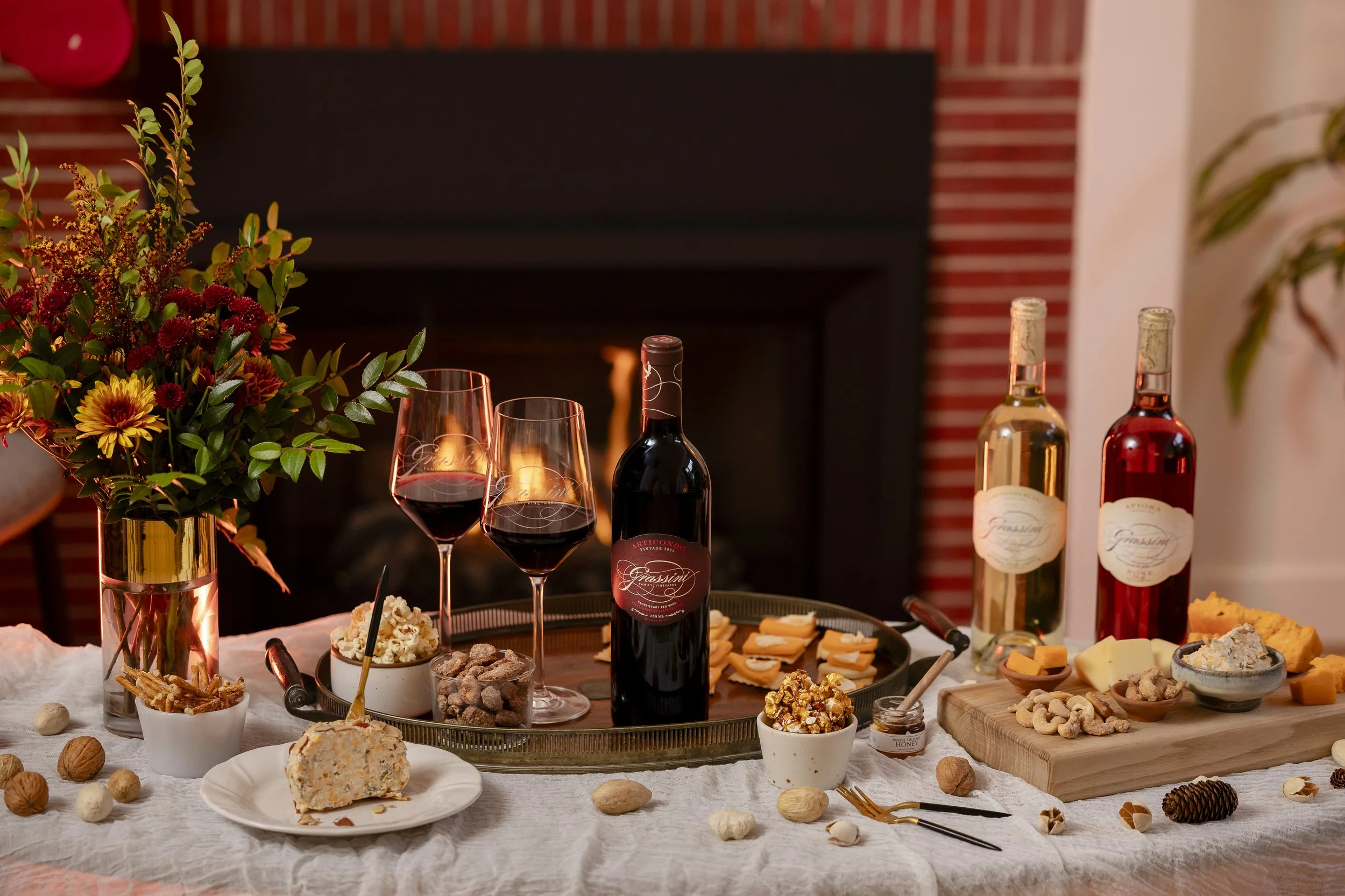 Bottles of wine on a table with seasonal appetizers.