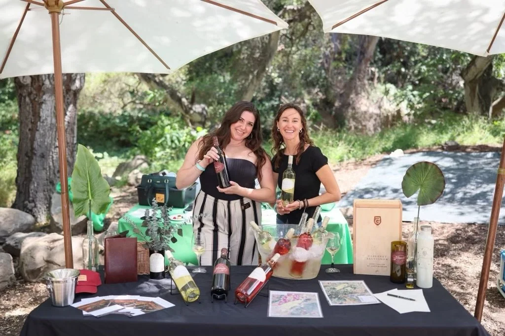 Two GFV staff members pour wine at the SB Food and Wine Festival