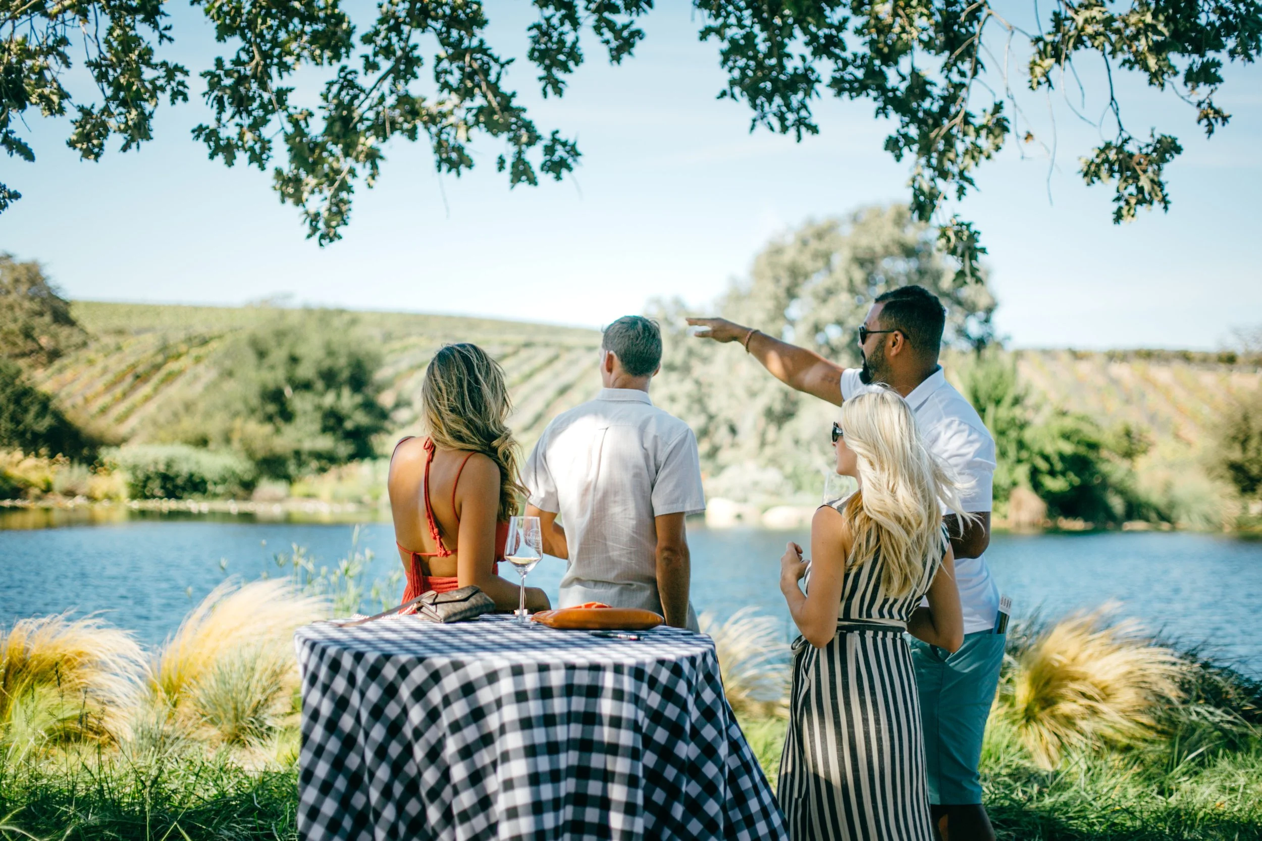 Guests look out at the scenic vineyard view at the lakeside location at Grassini Family Vineyards.