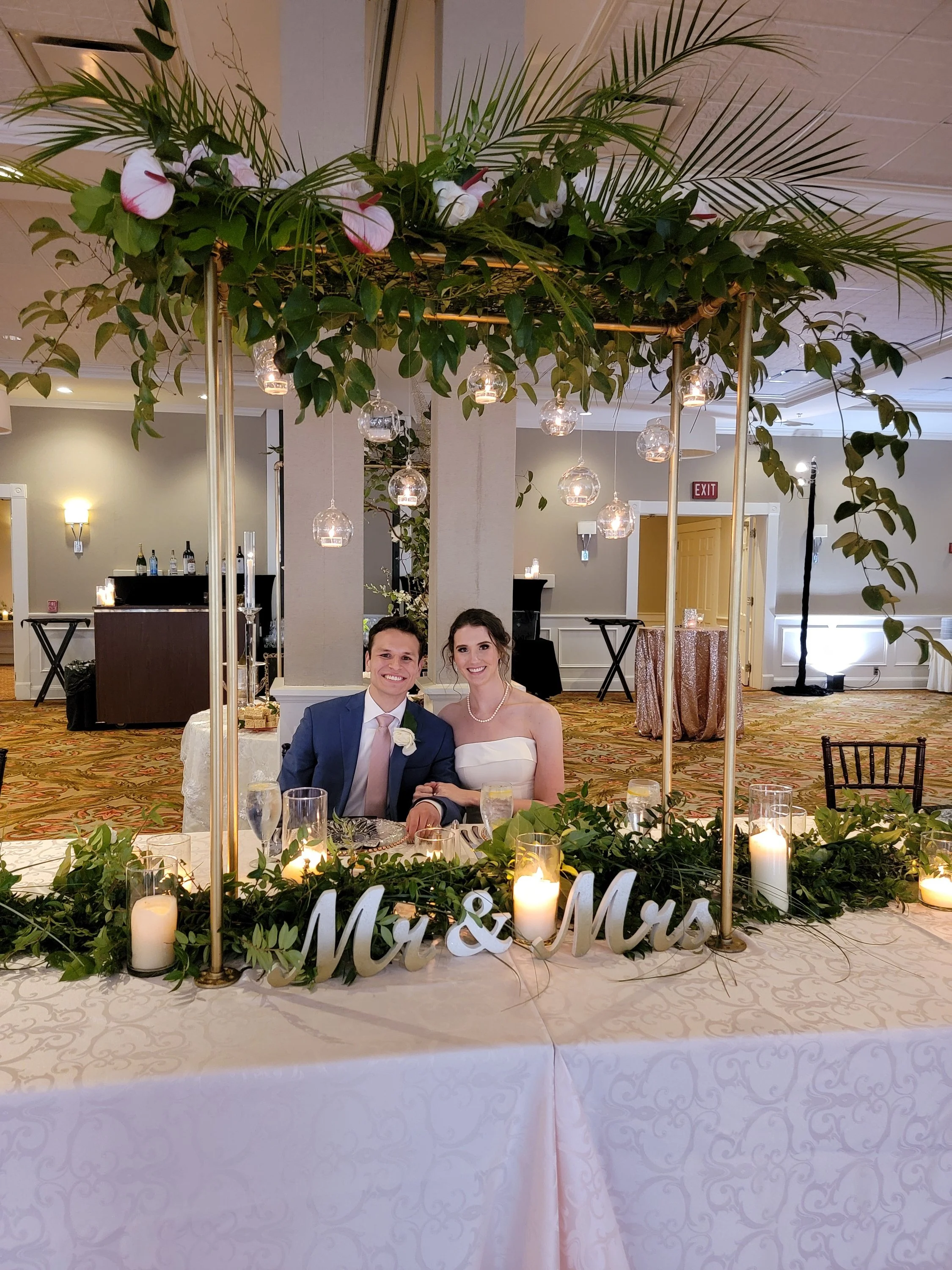 Bride and Groom at wedding table flowers and decorations by Kathy Reynolds Wedding Florist.jpg