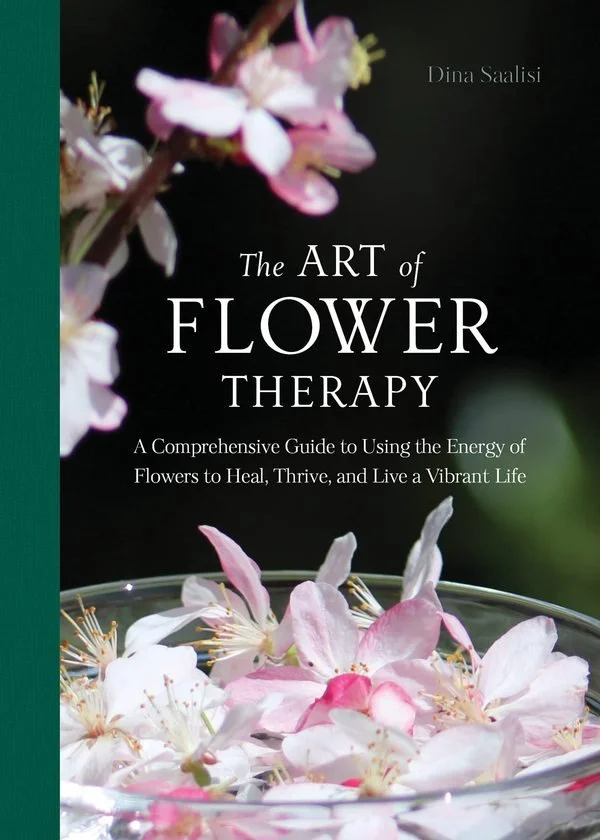 Book cover titled "The Art of Flower Therapy" by Dina Saalisi, featuring pink and white flower petals and blossoms with a dark background.
