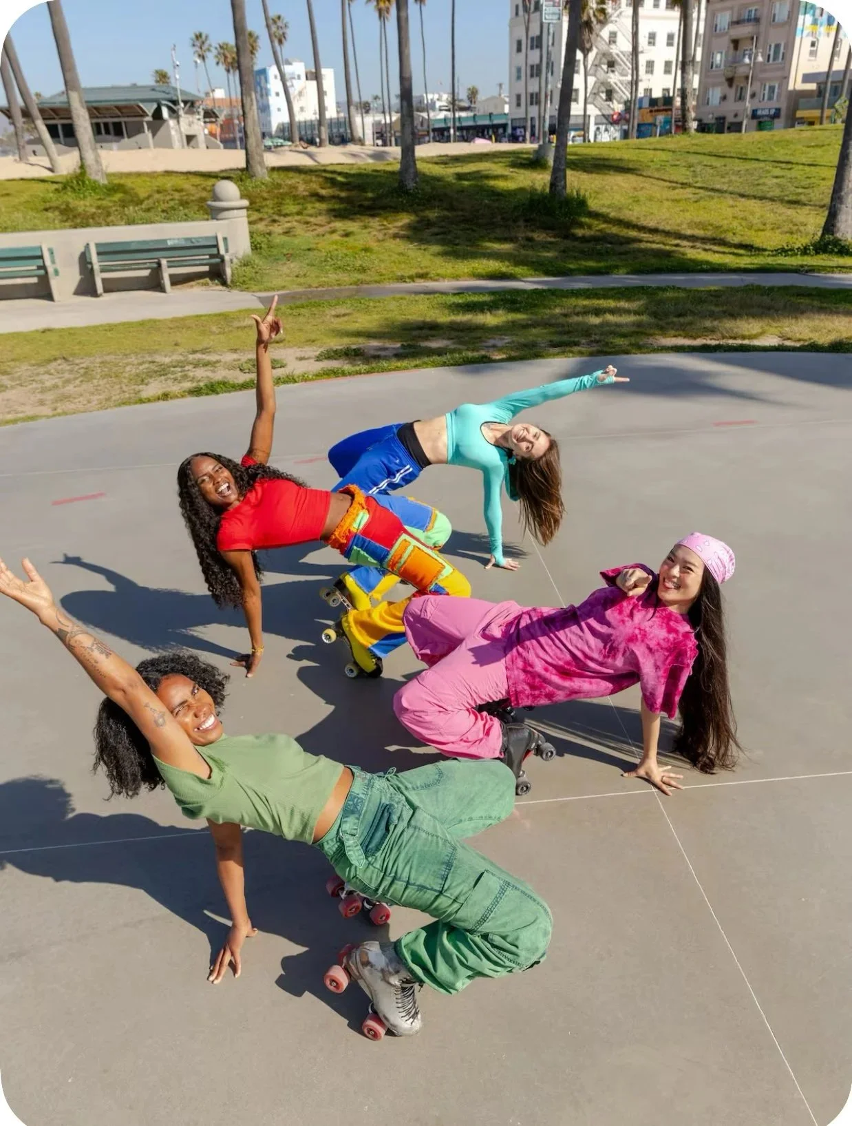 Group of diverse women doing high- energy roller skating performance outdoors