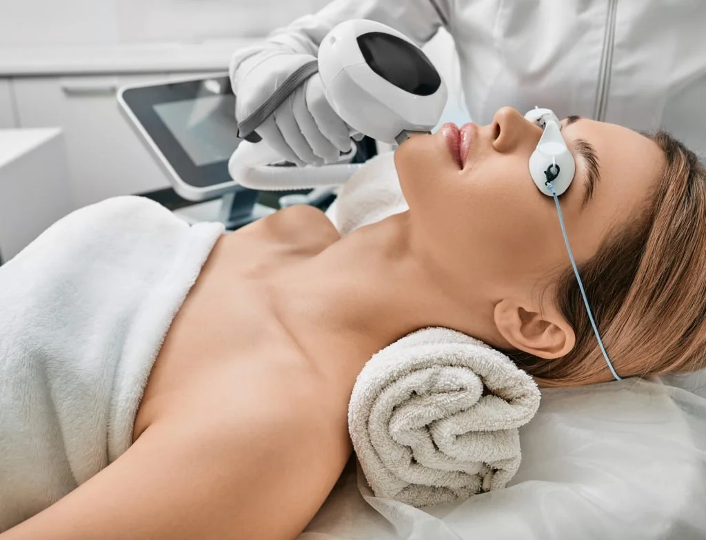 Woman receiving laser skin treatment in spa