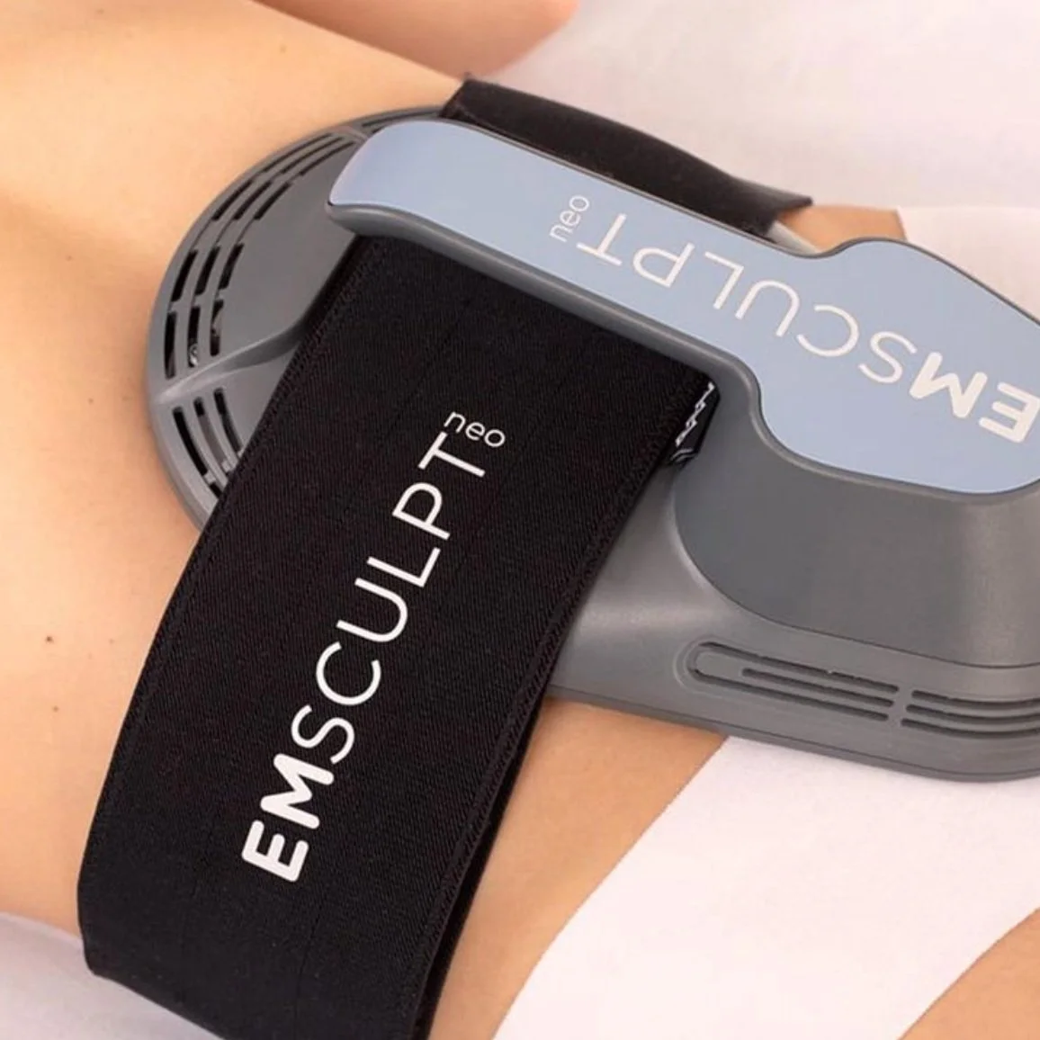 Emsculpt Neo device used on a person's abdomen for body contouring or muscle toning.