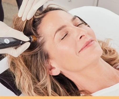 Woman receiving facial treatment with dermal device
