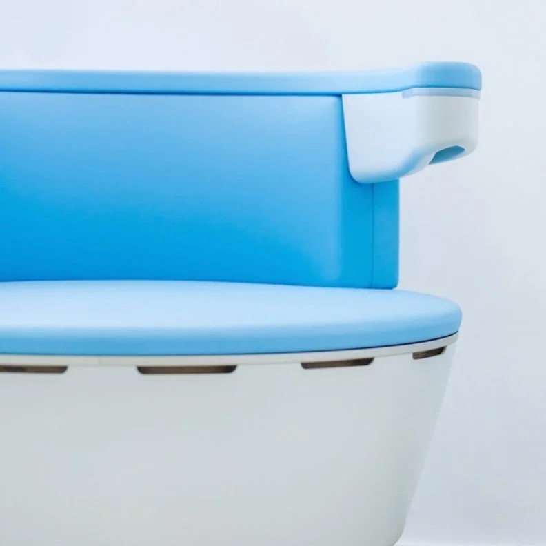 Close-up of a modern blue and white seat with a rounded design.