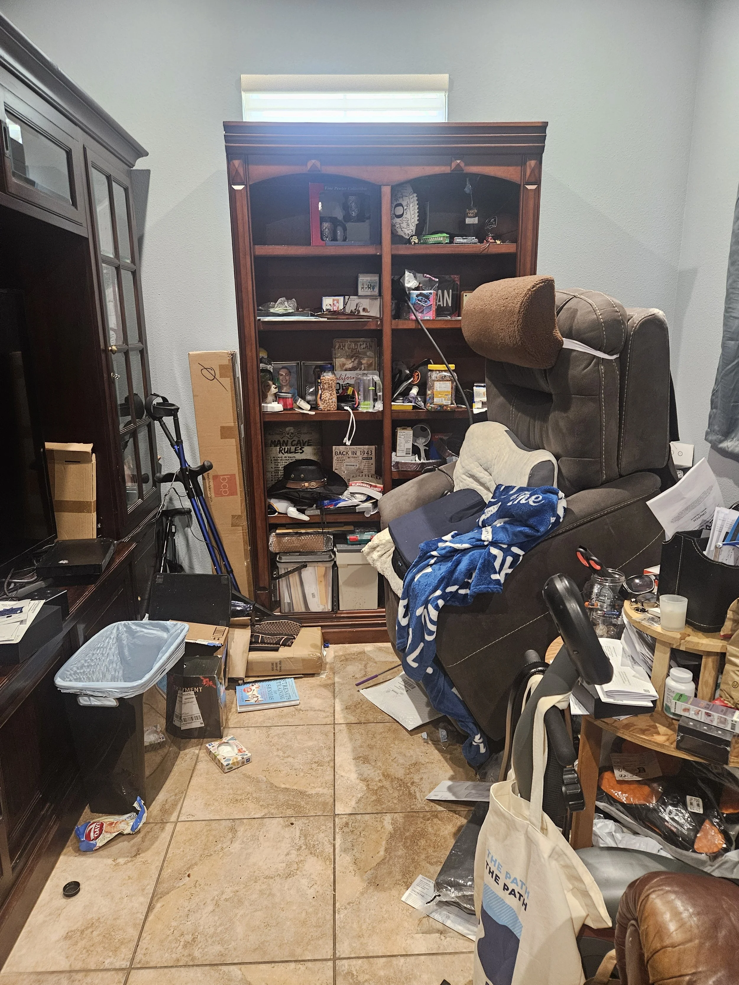 Cluttered den with boxes and piles before organizing in Rio Vista, CA