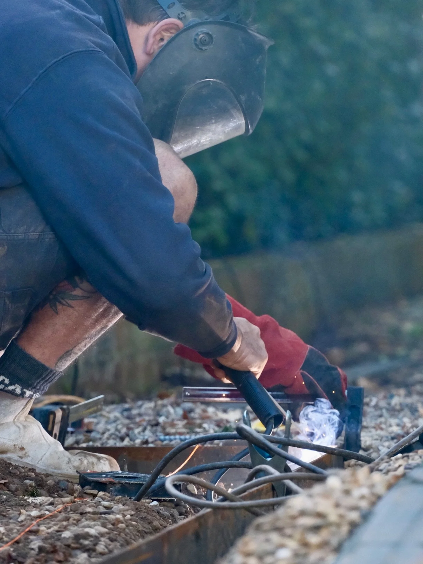Behind the scenes at our project in Burradoo - welding and installing steel garden edging.