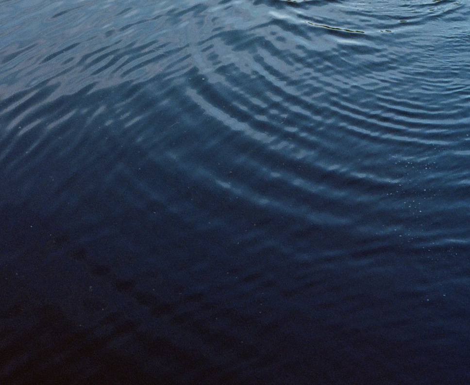 A close-up of a calm body of water with gentle ripples on the surface.