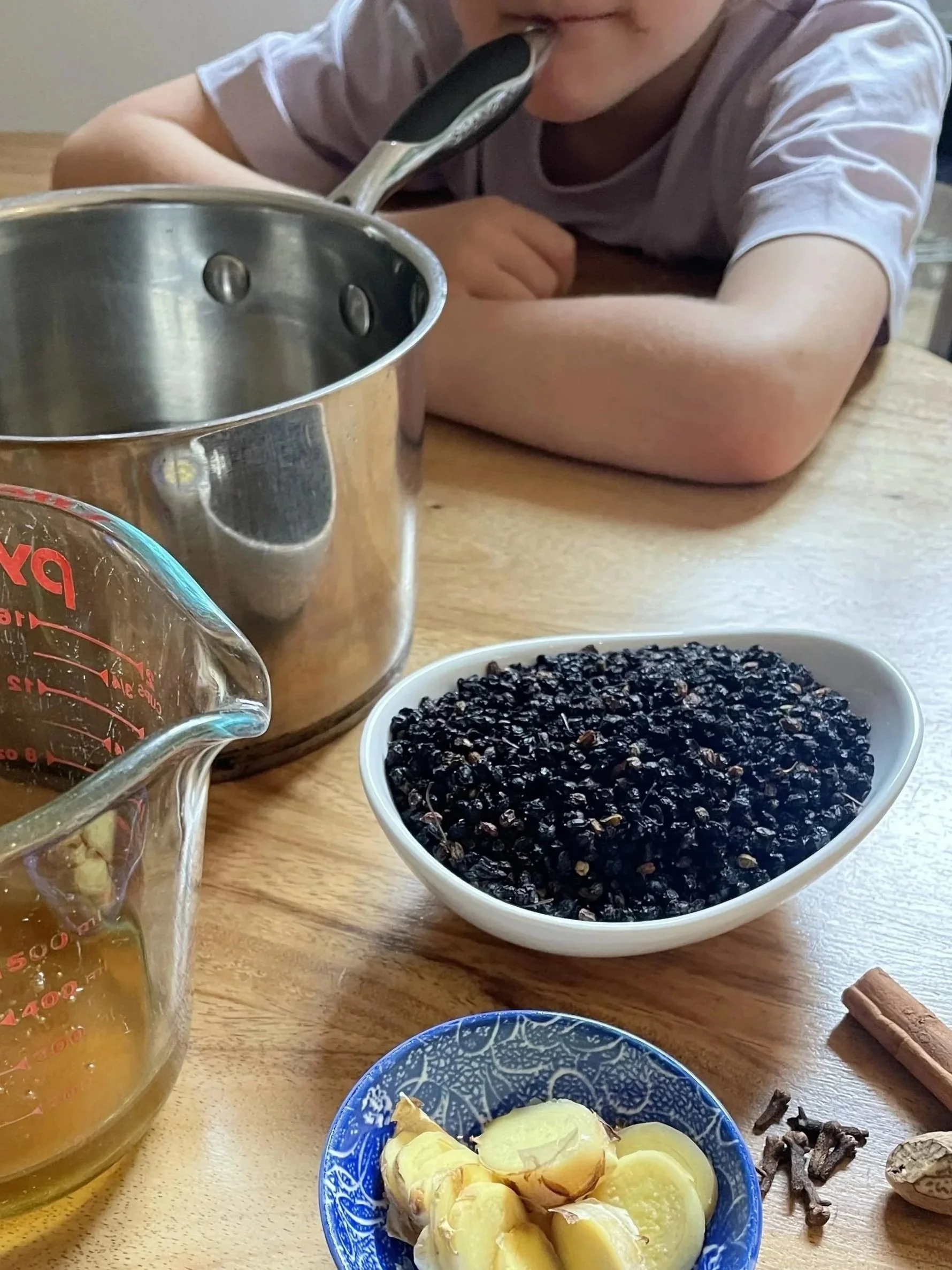 Ingredients on a table for homemade elderberry syrup