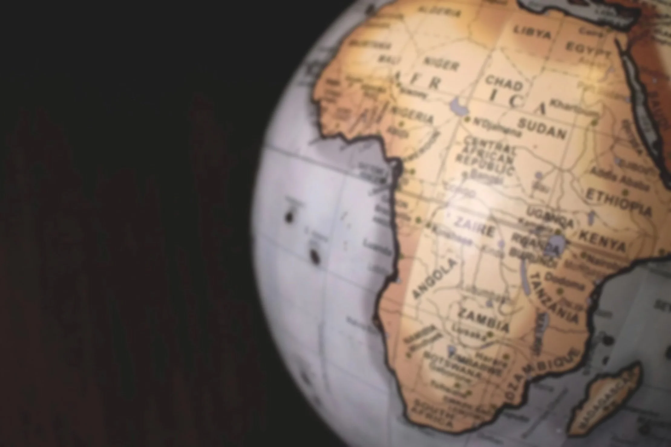 A globe showing the continent of Africa, including countries like Libya, Chad, Sudan, Ethiopia, Kenya, Uganda, Tanzania, and South Africa, with parts of the Atlantic Ocean visible on the left.