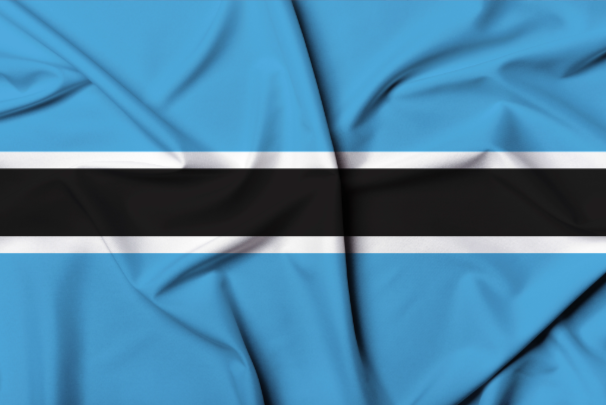 Close-up of fabric with a design inspired by the Botswana flag, featuring blue, black, and white horizontal stripes.