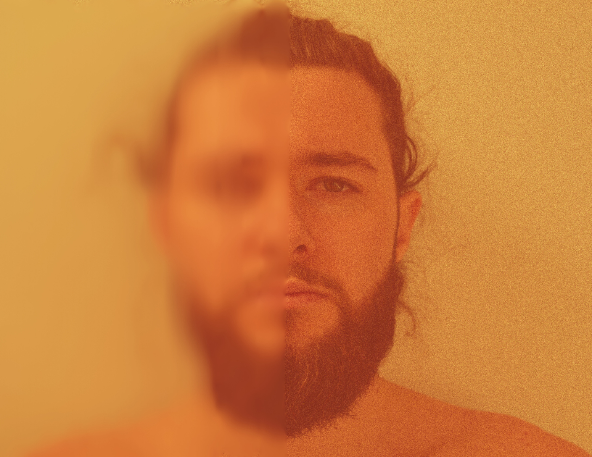 A dual-sided portrait of a man with a beard, one side blurred and the other in focus, against a plain background.