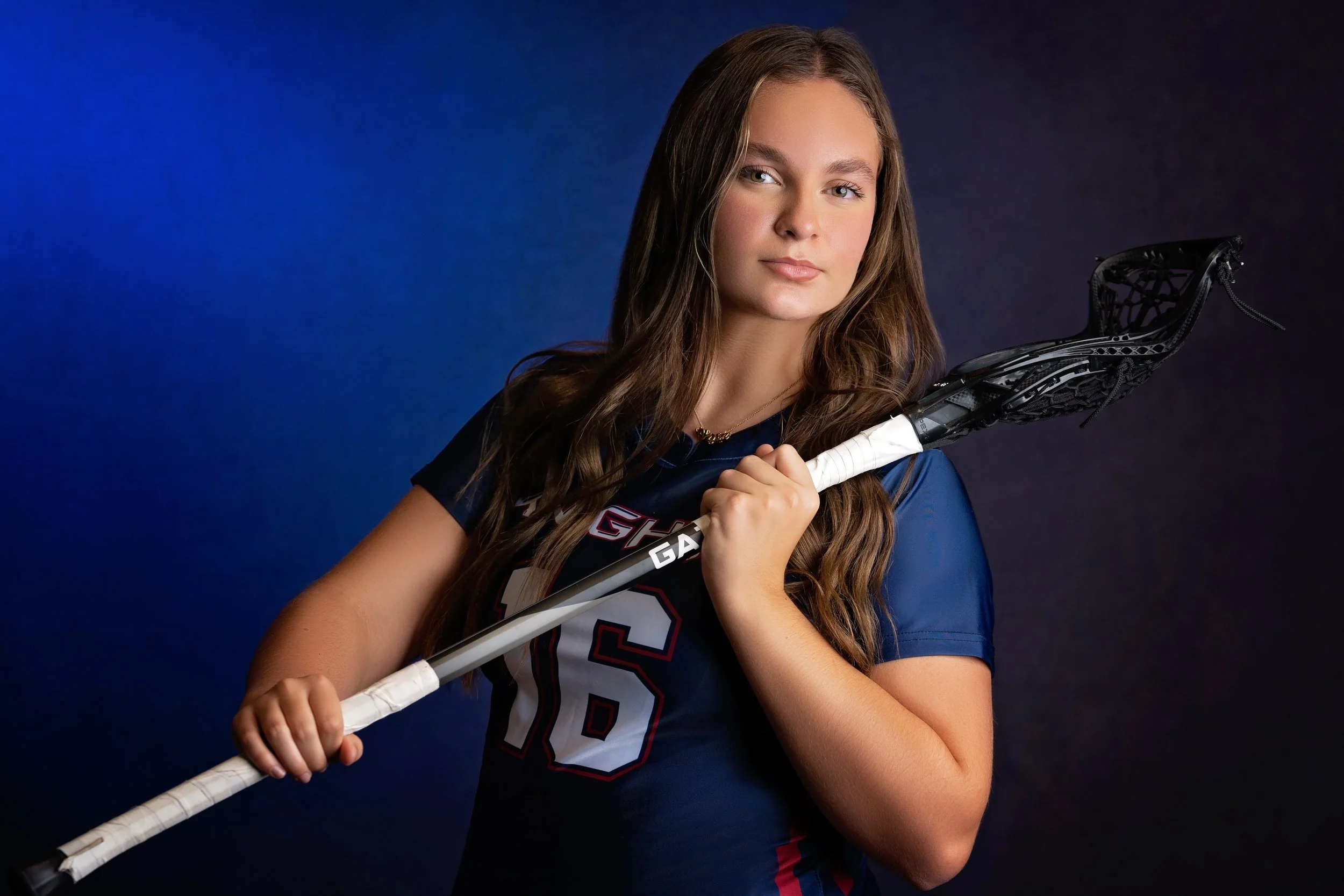 A lacross player poses during her beyond the Game session in studio near Gretna